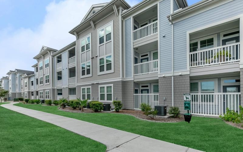 a building with a lawn and a walkway