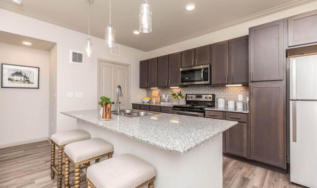 a kitchen with a marble island